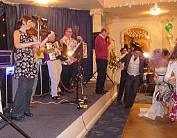 A view of the Pluck & Squeeze band with Chris Oates calling the steps at the ceilidh.