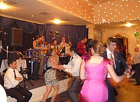 A view of the band and guests dancing.