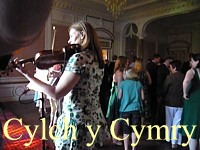 Dancing a Welsh folk dance Cylch y Cymry at Court Colman Manor, near Cardiff, Wales.